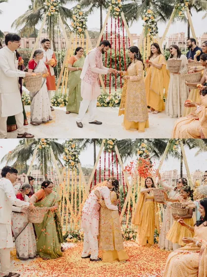 A joyful moment from a Haldi ceremony, with the couple embracing under a shower of flower petals.