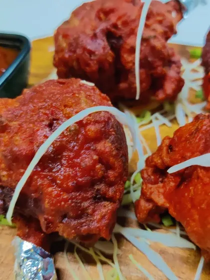 A close-up of the crispy and juicy Chicken Lollipop. You can see the texture and the delicious coating that makes it so special.