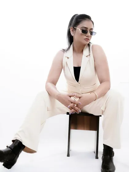 A high-key studio portrait with a "boss babe" aesthetic. This shot demonstrates a different style, using clean white backgrounds and strong posing to create a modern and confident brand image.