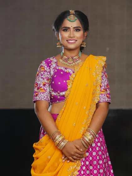My cousin Deepa ready for a family function. I created a vibrant look with a smokey eye and bright outfit to match the festive mood.