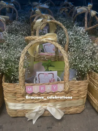 A closer look at the personalized first birthday baskets for Miraya. The custom name banner and coordinated ribbons make each gift feel unique.
