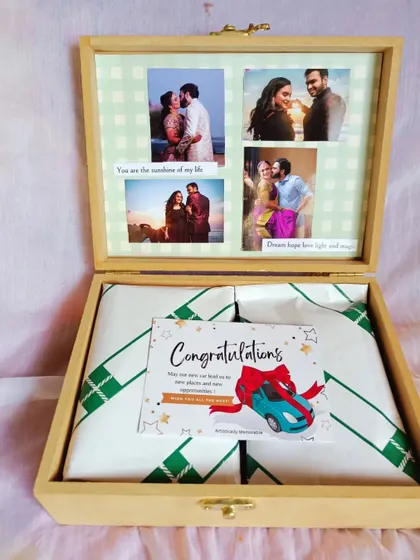The contents of the congratulations hamper are neatly wrapped inside, just waiting to be discovered. The photo collage on the lid is the first thing he'll see.