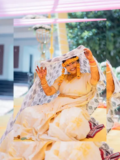 A happy bride posing with a dupatta after her Haldi ceremony, a moment of pure joy.