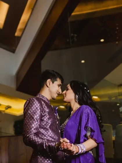 A low-angle shot of the couple about to share a kiss, their faces framed by the ceiling architecture. This creative composition adds a dramatic and intimate feel to the portrait.