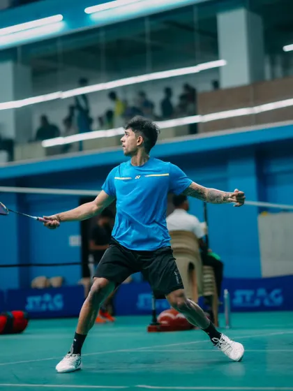 A player in a low, ready stance, anticipating the opponent's next move. This image showcases the focus and intensity that participants bring to the game.
