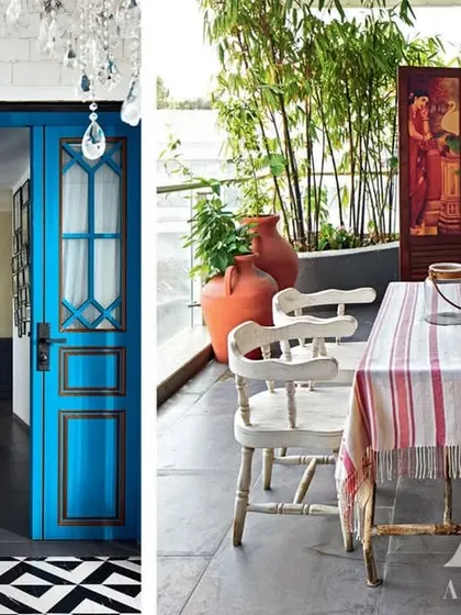 For Kangana Ranaut's home, we blended her Himachali heritage with a modern Mumbai sensibility. This image shows the eclectic mix of a bold blue door, classic black-and-white flooring, and a rustic outdoor dining setup, all featured in Architectural Digest.