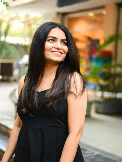 A beautiful, candid-style portrait of a young woman with a natural smile. The soft, outdoor lighting is very flattering.
