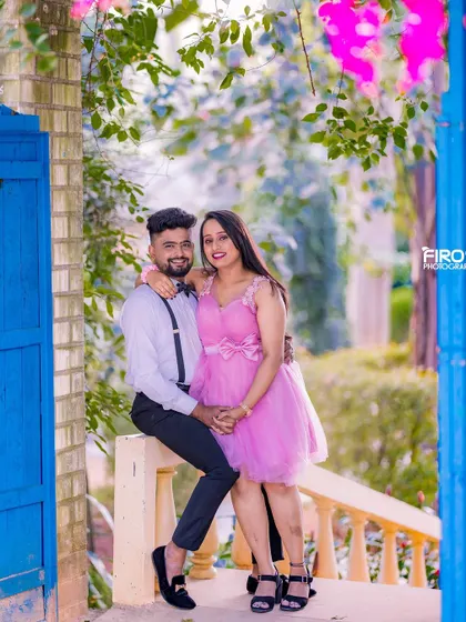 A happy, coordinated look with the couple on a balcony. Their casual outfits and their close pose make for a very intimate and romantic portrait.