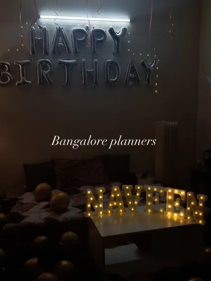 Even a simple room can become the perfect spot for a surprise. For this birthday, I used "Happy Birthday" foil balloons, fairy lights, and illuminated marquee letters on the table to create a cozy and personal celebration space.