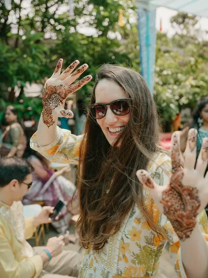 A guest shows off her freshly applied henna, a beautiful souvenir from the Mehendi celebration.