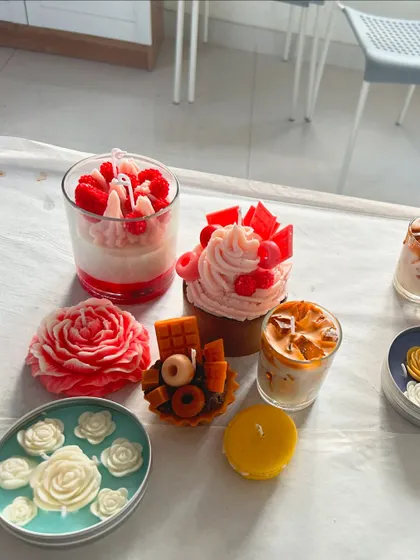 A collection of beautifully crafted dessert and floral candles made during one of our weekend workshops.