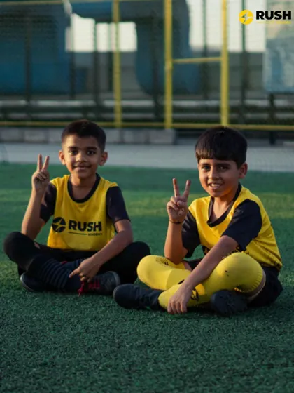Two young players from our academy take a break during training. The bonds formed here go beyond the field, creating a supportive and friendly team atmosphere.