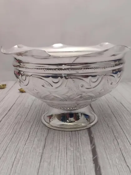 A German silver flower bowl with a scalloped edge. This versatile bowl can be used for flowers, prasad, or as a decorative piece.