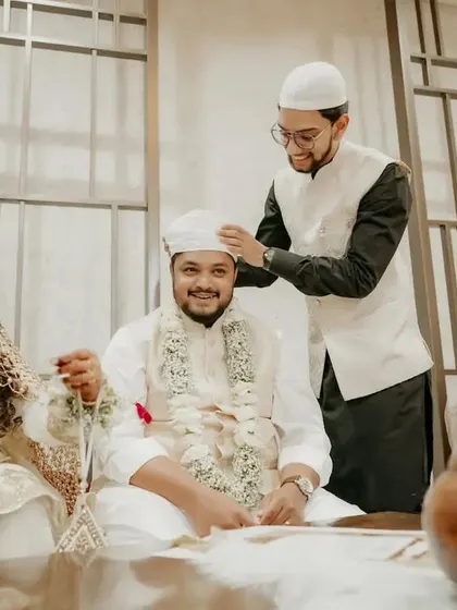 A candid moment from a Nikah ceremony, showing the couple and their family during the rituals.