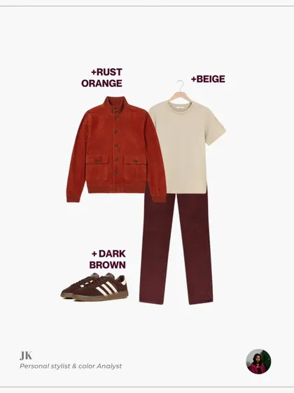 Here, wine-colored trousers are styled with a beige t-shirt, a rust-orange jacket, and dark brown sneakers for a sophisticated, tonal outfit.