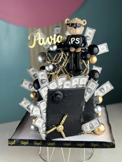 Making every celebration richer with a cake that's worth every cent. This money-themed cake features a fondant safe overflowing with edible cash.