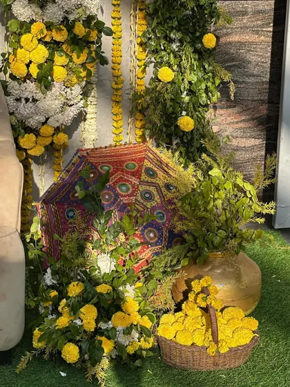 Another close-up of the decor details, focusing on the fresh marigold flowers and traditional elements that give the setup an authentic and festive feel.