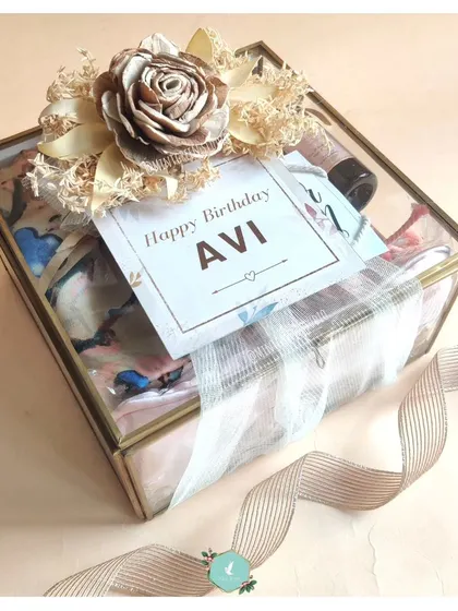 An elegant glass and brass display box used for a birthday hamper. This luxurious packaging turns the gift into a beautiful keepsake box.