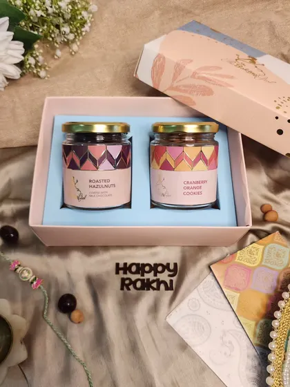A simple and sweet gift. This box contains two jars of my best-selling treats: roasted chocolate-coated hazelnuts and cranberry orange cookies.