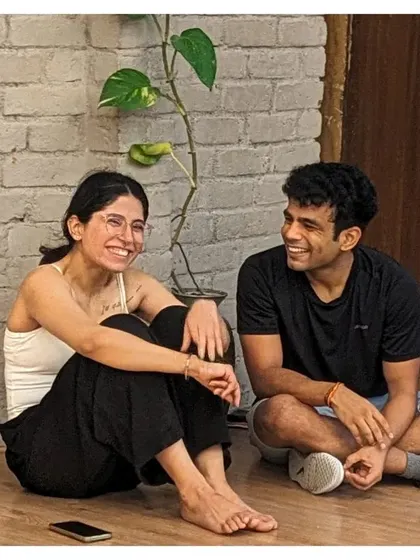 A moment of rest and laughter between two students during a break in our energetic Bollywood workshop.