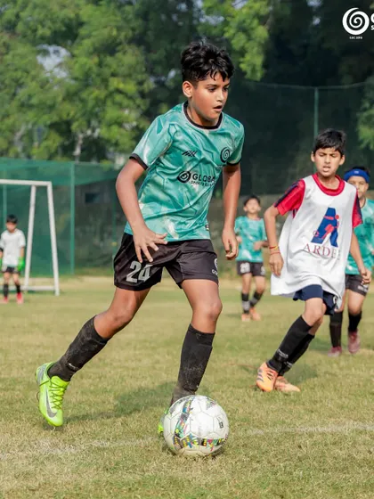 Dribbling with purpose, this player advances the ball up the field.