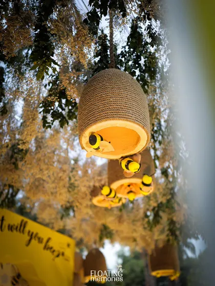 A closer look at our charming, handmade beehives, complete with cute little bees peeking out. These were hung from the trees and canopy, adding a playful and thematic detail throughout the space.