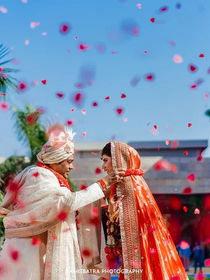 A perfect moment from an Anand Karaj ceremony, where flower petals rain down on the couple in their Sabyasachi outfits.