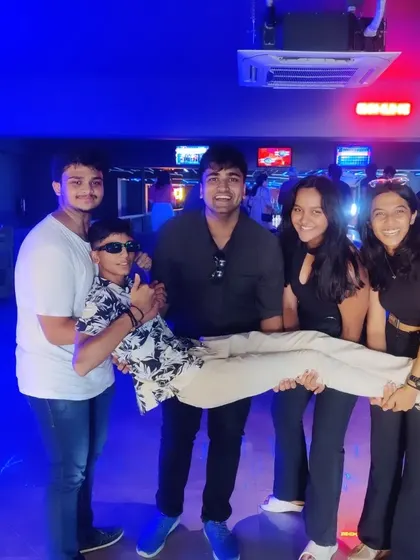 Enjoying every moment with the best squad. This group is having a blast, with one friend being playfully lifted by the others.