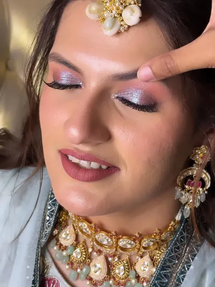 A detailed shot of the eye makeup for Muskan's Mehendi. The blend of pink and silver shimmer is ethereal and beautiful.