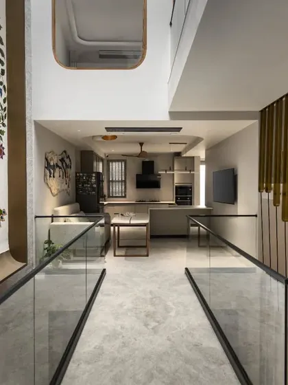 The bridge on the first floor of the Slender House connects the front and rear of the home. It overlooks the central courtyard, which features the 'Tree of Life' artwork, maintaining a strong visual connection.