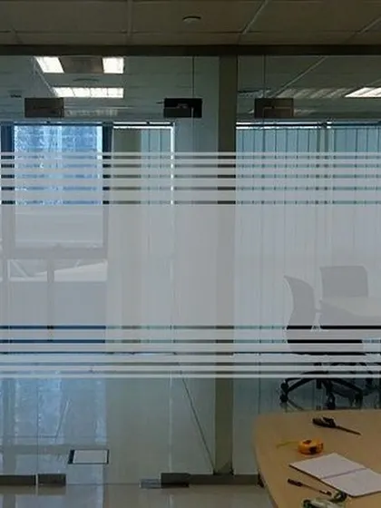 This frosted film uses clean horizontal stripes to create partial privacy for an office meeting room. It's a popular and professional choice that obstructs the direct line of sight while still allowing light to pass through.