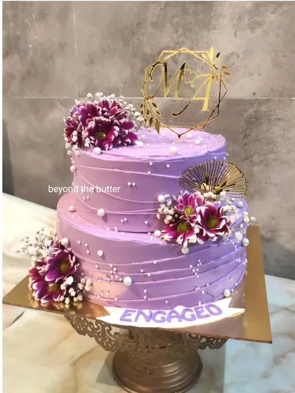 It was all purple for this two tier engagement cake. I used a lovely lavender buttercream and decorated it with fresh purple chrysanthemums and baby's breath for a dreamy, romantic look.