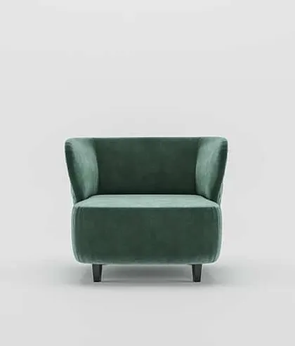 A front view of the green velvet armchair, showing its simple, elegant form and invitingly plush seat.