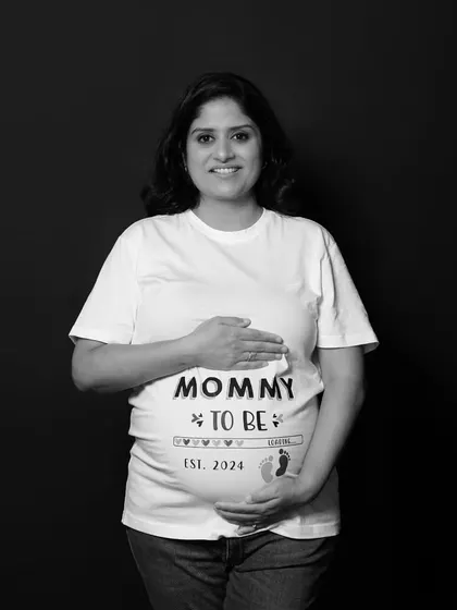A simple and classic black and white portrait of the "Mommy to be" in her themed t-shirt. This solo shot beautifully captures her pride and happiness.