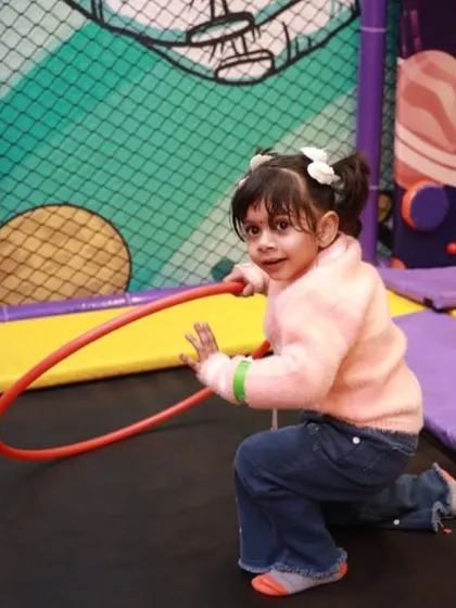 Having a hula-hoop of a time on our trampoline. We provide simple toys and props to add another layer of fun to the play experience.