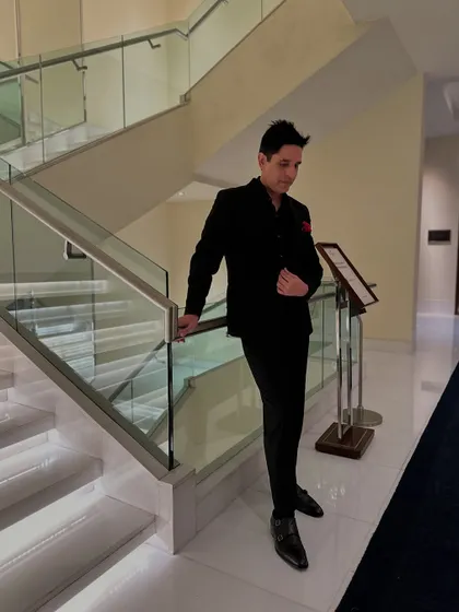 A candid shot looking down, adjusting my suit. It's the small details that make up the bigger picture, both in style and in music.