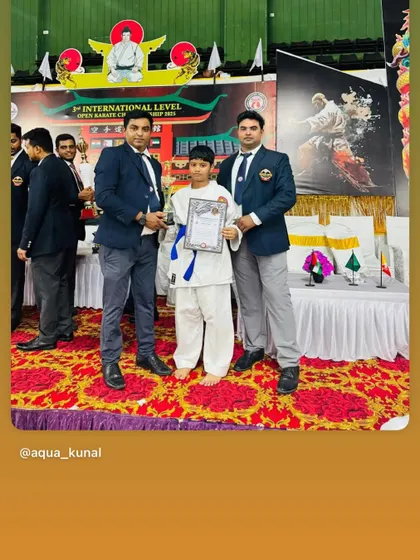 My student receiving his trophy and certificate at the 3rd International Level Open Karate Championship. We guide our athletes to compete at the highest levels.