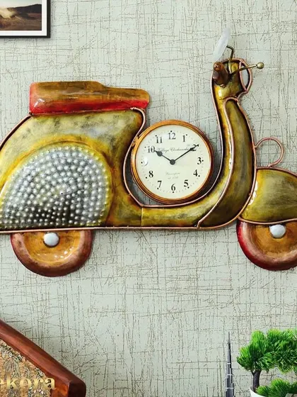 A whimsical vintage scooter wall clock, handcrafted from metal with a distressed finish for a retro look.