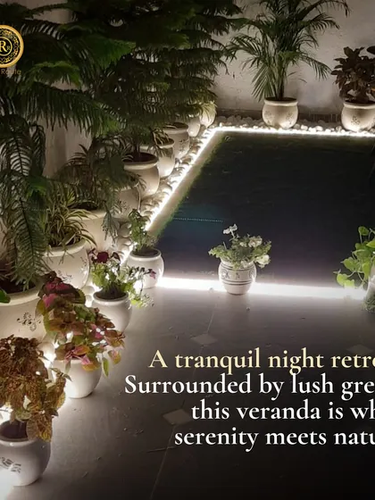 A tranquil night retreat. Surrounded by lush greens, this veranda is where serenity meets nature, with potted plants beautifully illuminated by floor-level strip lighting.