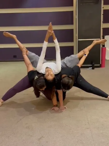 A beautiful ACRO split created by a group of dedicated students. This pose is a testament to teamwork, flexibility, and collective strength.
