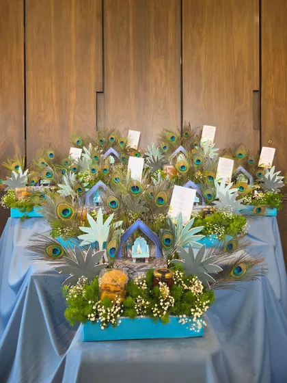 A wide shot of the impressive 'Little Kanha' themed gift display against a wooden backdrop.