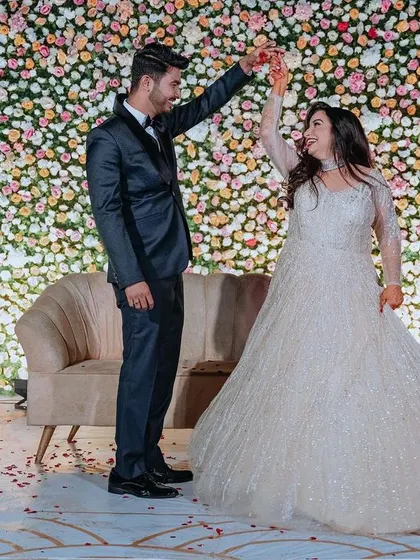 A symphony of pastel florals and soft lighting created the perfect backdrop for this elegant outdoor engagement stage.