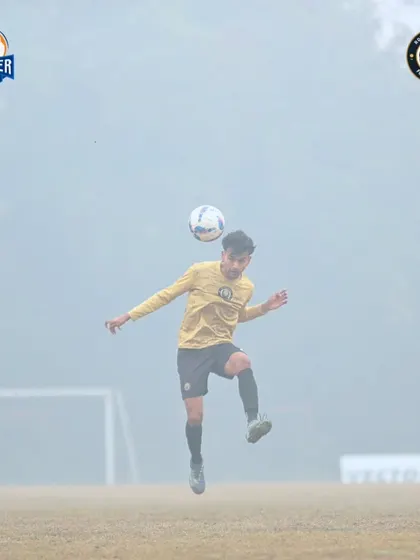 A player chests the ball down, showing great control and preparing for the next phase of play.