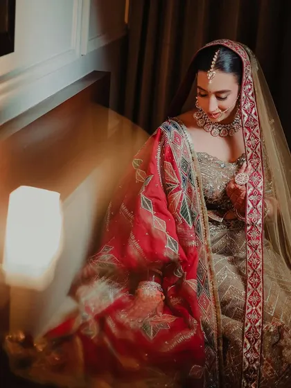 A soft and dreamy bridal portrait. The bride is seated, and a slow shutter speed is used to create a gentle motion blur, adding an artistic and ethereal quality to the image.