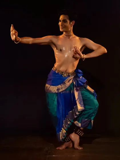 A strong, defined stance from a live performance. This demonstrates the precise body control and posture that forms the foundation of the Kuchipudi technique.