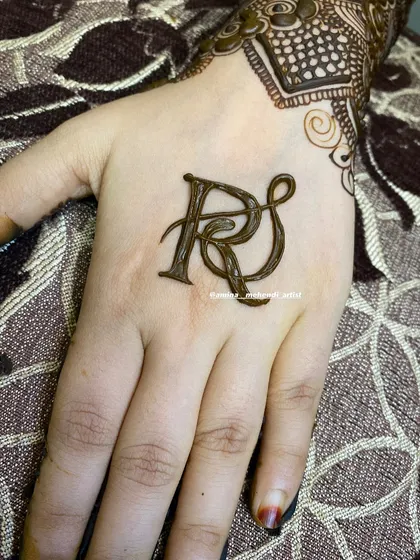 An intricate monogram style for the initials 'RS', creating a unique and personal focal point on the back of the hand.