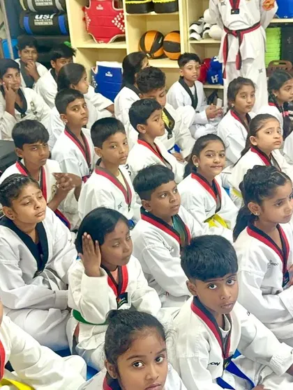 Young students sitting patiently, waiting for the belt ceremony to begin.