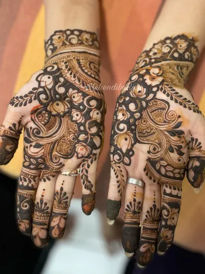 A Karwa Chauth design from 2022, featuring peacocks and floral motifs for a festive and traditional look.