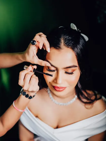 The final touch. Applying mascara to make the eyes pop and complete this glamorous bridal look.