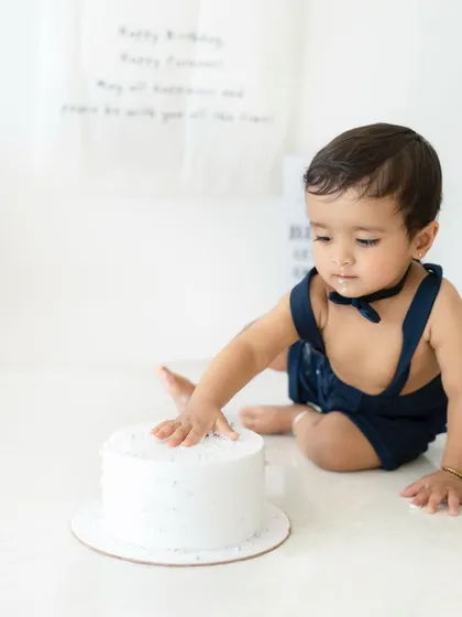 The first touch of the cake! This is the moment of anticipation before the messy fun begins. I capture the entire story of the cake smash, from start to finish.